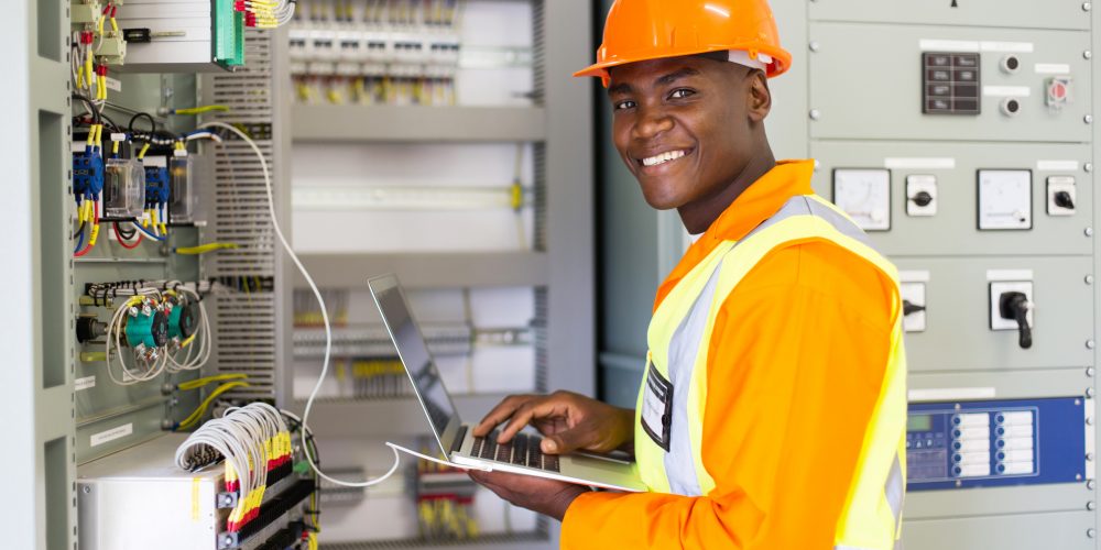 african electrical worker using laptop computer commercial roofing electrician